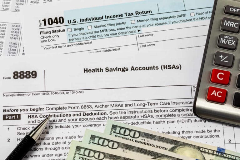 Tax forms, calculator, and cash for U.S. taxes