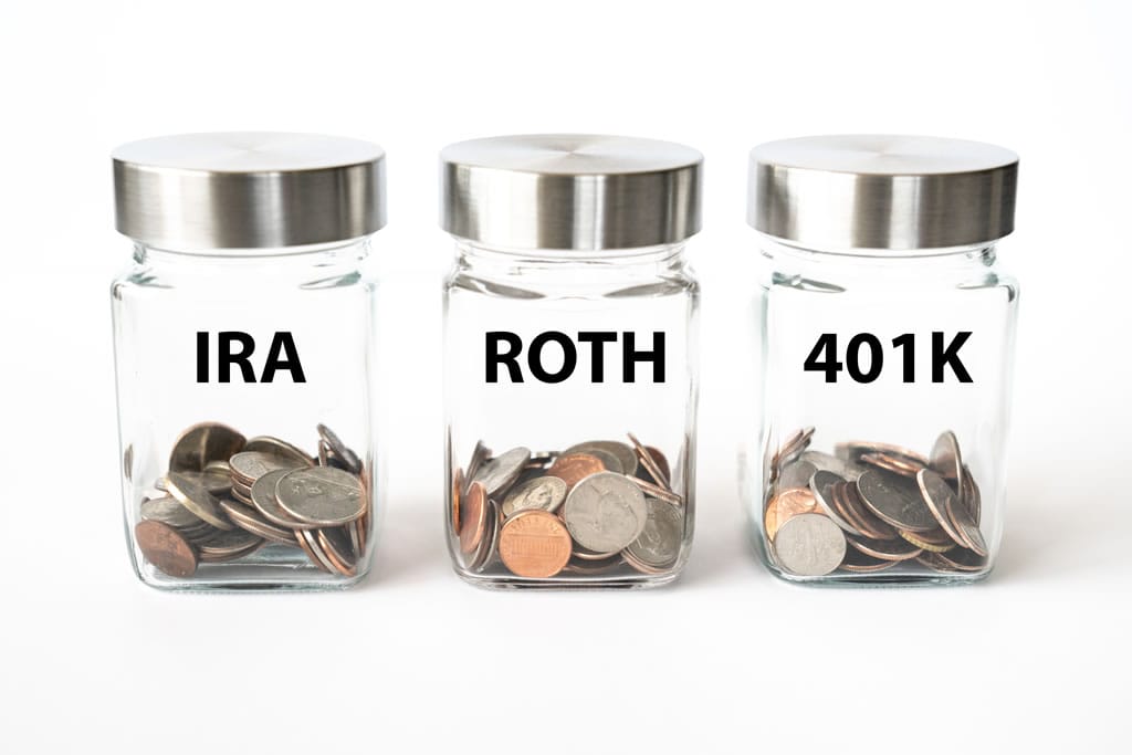 Jars labeled IRA, Roth, 401k with coins.